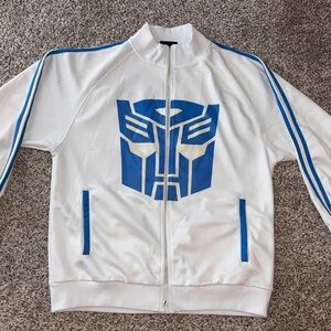 SOLD White Jacket with Blue Transformer Logo
SOLD